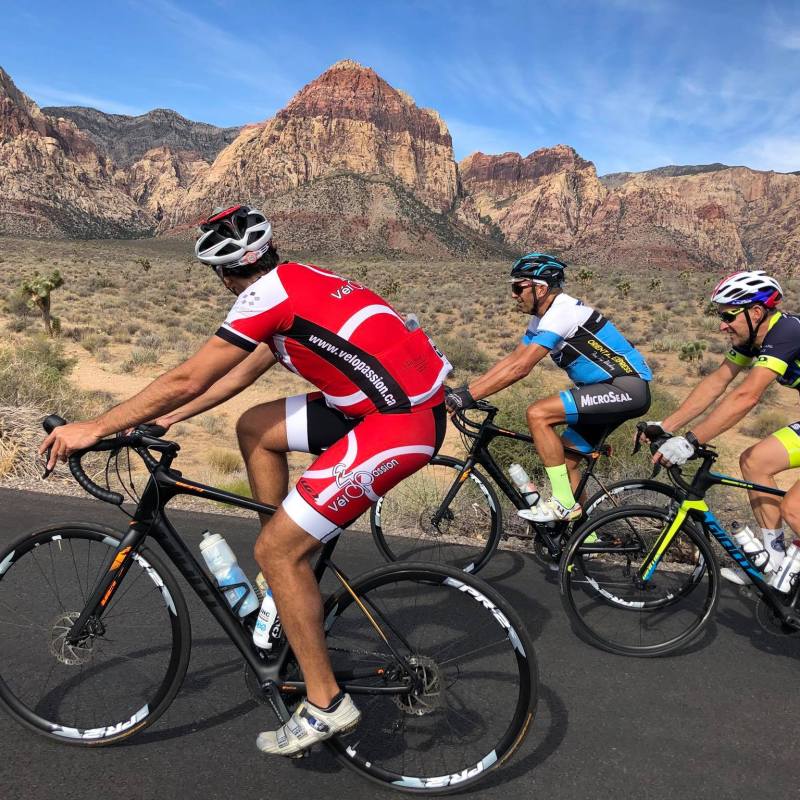 a group of people riding on the back of a bicycle